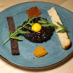 raw seal with a quail egg at kukum kitchen in Toronto, Canada 
