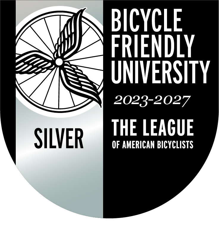A black and silver logo for a bicycle friendly campus award