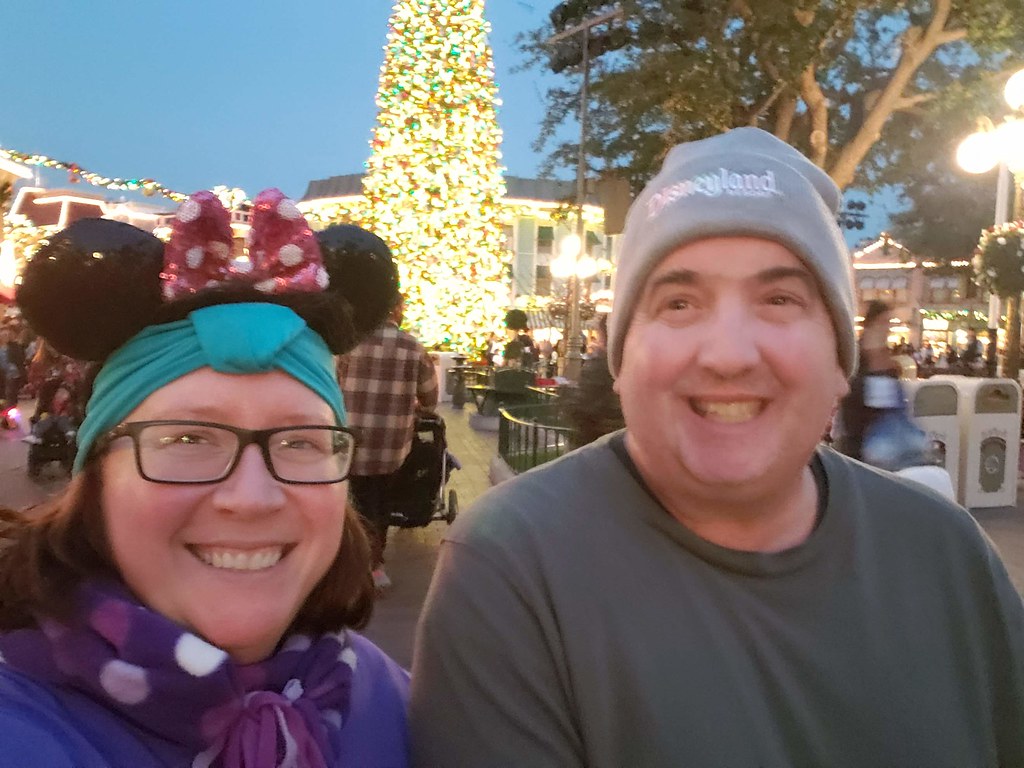 Couple in front of Main St USA christmas tree