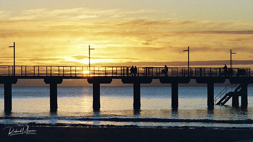 Together - Spotmatic F and Kodak Portra 800 by Richard Meares, A couple sit and watch the sunrise while anglers optimistically cast their lines. Taken with Asahi P
