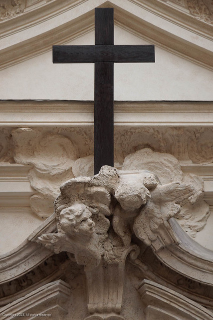 Iron cross above the door at the Church of Santa Maria Maddalena