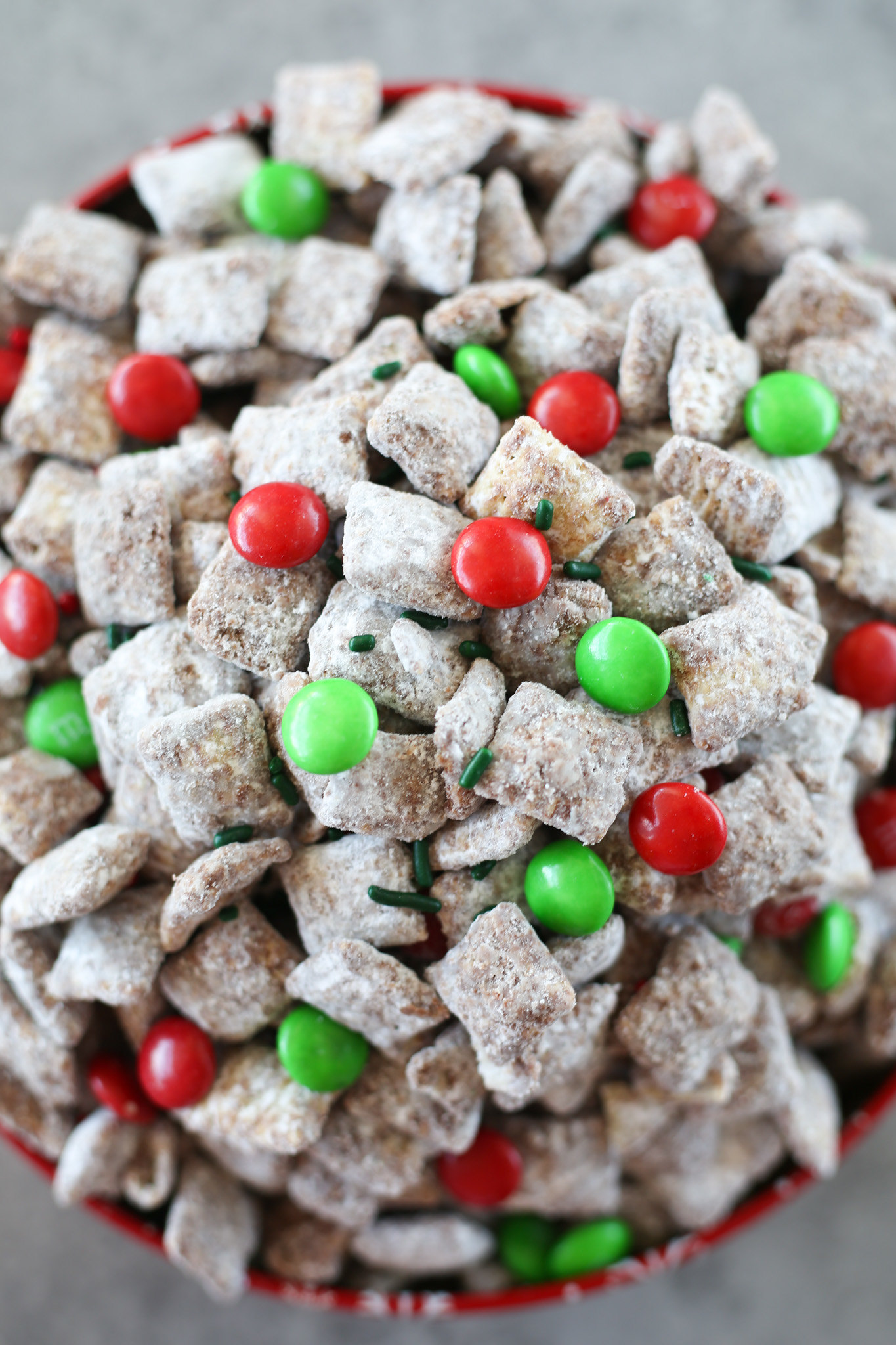 Overhead shot of christmas muddy buddies in a red tin