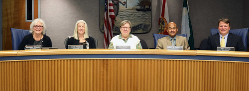 A photo of all five Alachua County Commissioners at the dias.