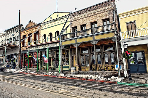 horizontal day daylight outdoors outside town street coveredboardwalk snow winter ice cold buildings structures architecture highlights shadows hdr photomatix multistory cstreet nv virginiacity nevada storefronts people windows doorways nenches townclock historical western wildwest ghosttown