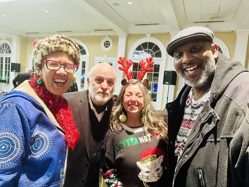 Margie Perez, Father Ron, Gerald French at the WWOZ Family Holiday Party, Dec 13, 2023 at the Pavilion of the Two Sisters in City Park