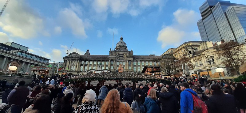 A very busy Christmas market in Birmingham, with a lot of people gathered around, in Victoria Square.