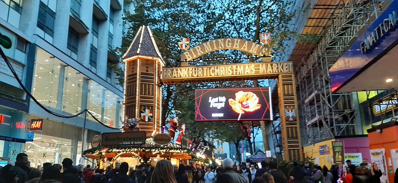 The entrance to the Christmas market, with a large sign held by a tower.