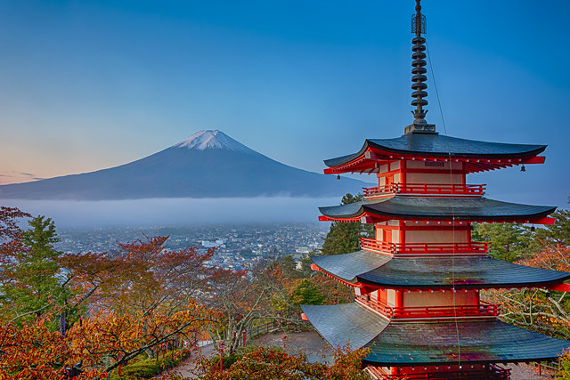 Japan Travel Destinations. Renowned Kiyomizu-dera Temple Pagoda Against Kyoto Skyline  and Traditional Red Maple Trees in Japan.
