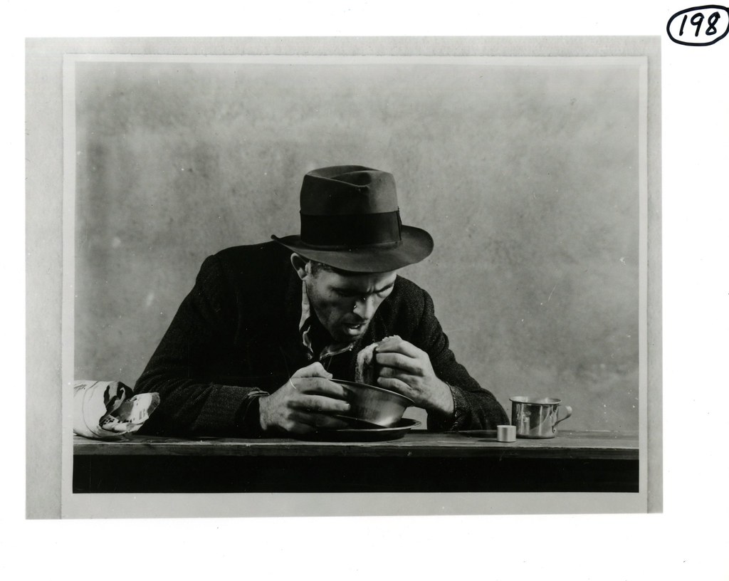 Man Eating from A Tin Bowl