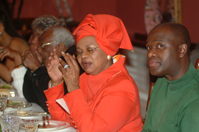 DSCF0818 Freedom Celebration Dinner at the South African High Commission Residence Kensington London. Rev Desmond Tutu RIP South African Anglican Archbishop with Her Excellency Dr Lindiwe Mabuza RIP in Orange plus Thandi Klaasen RIP SA Jazz Singer