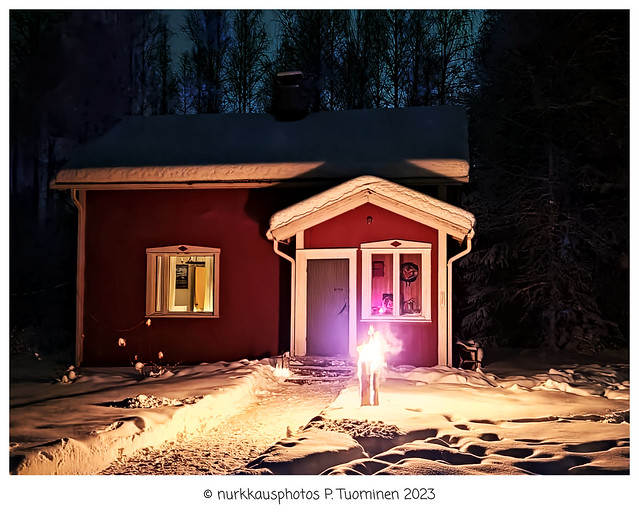 Swedish torch front of Finnish cabin