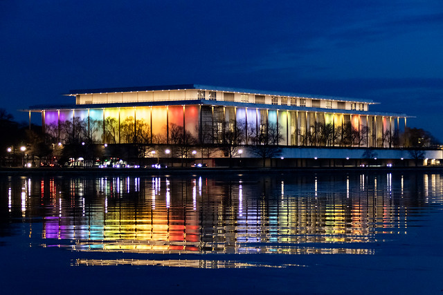 illuminated Kennedy Center reflecting on the glassy Potomac River