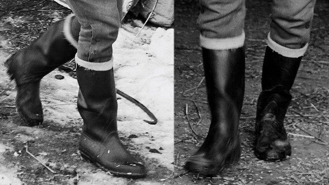 The rubber boots, with turned down tops,  of a handsome elegantly dressed Swedish farmer.