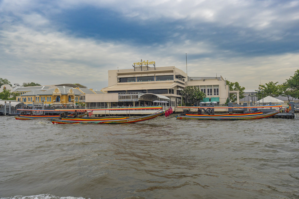 Long-tail boats at Tha Chang pier on the Chao Phraya river in Bangkok, Thailand