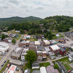 20230525-USDA-RD-WV-LSC-0705 Aerial view of downtown Gassaway, WV, on May 25, 2023.

The new Elk River Trails, part of the Pioneer Trails Network runs through Gassaway. This trail follows a former railway and train station that has now been transformed into an event center with an event field and bandstand. It connects various towns and offers scenic pathways, making it an ideal spot for hikers, bikers, and runners to enjoy the beautiful surroundings.
       The 73-mile Elk River trail winds through Braxton and Clay County, and the 102-mile Elk River Water Trail flows from Sutton to Charleston, WV. These trails are included in the Pioneer Trail Network that connects to the Ohio River. A study stated that for the Elk River Trails, a 4-million dollar investment into the four trail towns of Gassaway, Clay, Sutton, and Clendenin during the next 10 years could result in more than 390 million dollars in economic impact in the region over 15 years. 
The river provides excellent fishing opportunities and is ideal for leisure floating and kayaking. Unlike the whitewater rivers in West Virginia, this river is family-friendly and can be safely navigated by users of all ages and abilities. Nicholas and Webster counties are both working on enhancing their recreation amenities and improving connectivity to Snowshoe Resort to take advantage of an established recreation hub. Every county or community has the opportunity to create recreation-related businesses such as rental shops, restaurants, and commercial and lodging establishments and to showcase local artisans, musicians, and unique town history. 
This project aims to provide infrastructure and support services for community and economic development in all trail town communities within the Pioneer Network. The goal is to develop trail towns in the Pioneer Network region by leveraging the state&#039;s thriving tourism industry. The approach will be comprehensive and regional, with an emphasis on distressed counties. It will include infrastructure development, facility construction, and ancillary activities necessary to create prosperous and thriving communities. The strategies used will address various needs identified by communities and can involve county, state, and federal entities.
The strategy builds on the success of Advantage Valley&#039;s FASTER WV initiative to facilitate the start-up and expansion of businesses with:
1.Develop marketing materials to recruit Elk River Trails entrepreneurs and support existing businesses. 
2.Place business outreach ambassadors in Braxton and Clay Counties to recruit and link entrepreneurs to FASTER WV and other resources.
3.Provide coaching and technical assistance awards to help entrepreneurs&#039; start-up efforts. These awards can support training, marketing, and other essential aspects of starting a business.
4.Implement community improvement projects to make the trail towns more attractive for tourists. 
5.Implement a façade renovation grant program for &amp;quot;Main Street&amp;quot; businesses.


Their strategy is supported by the U.S. Department of Agriculture (USDA), Rural Development (RD), Rural Partners Network (RPN) SMART project approach. This approach has four key strategies, namely: 
1. Building on each region&#039;s competitive advantage and leveraging the marketplace 
2. Establishing and maintaining a robust regional infrastructure 
3. Creating revitalized, healthy, and resilient communities 
4. Developing talented and innovative people.

-----

RPN
The Rural Partners Network (RPN) is a government program that aims to assist rural communities in finding resources and funding to create job opportunities, build infrastructure, and support long-term economic stability. This network comprises federal agencies and commissions that work directly with rural communities to enhance their prosperity through job creation, infrastructure development, and community improvement. Led by USDA Rural Development, members of the RPN collaborate to identify resources to help rural people build the futures they envision for the unique places they call home.

RPN deploys federal staff to selected RPN Community Networks located across the United States. These RPN Liaisons collaborate with small, rural communities to understand their needs and the importance of leveraging the programs and resources of various funders and assistance providers to achieve their goals. The Liaisons provide assistance to local individuals in navigating programs, building relationships, and identifying community-driven solutions.

Participating RPN agencies and offices (rural.gov/about#block-views-block-partners-partners-listing) are also joining forces to promote rural priorities as federal programs and policies are developed to address funding gaps, increase access to technical assistance and ensure equitable access to federal funding.

For more information, please go to RURAL.gov, the official website of the Rural Partners Network.

Courtesy Media by Lance Cheung.