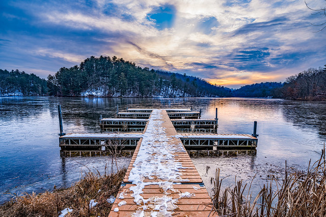 Dock and Frozen Lake At Sunset