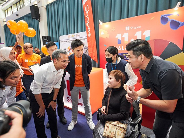 Kelly Chan (in the wheelchair) talking to YB Fahmi Fadzil, Minister of Communication at the OKU Celik Digital Programme