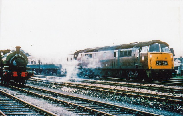 BR Class 52 diesel-hydraulic D1012 WESTERN FIREBRAND passing Slough Estates no.5, Hudswell Clarke 0-6-0ST 1709 of 1959.