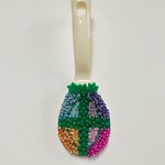 Garden Utensil Lacy stiff stuff painted and embroidered with beads, sequins and plastic flowers and glued to a plastic spoon, 8&amp;quot; x 3&amp;quot;, 2024