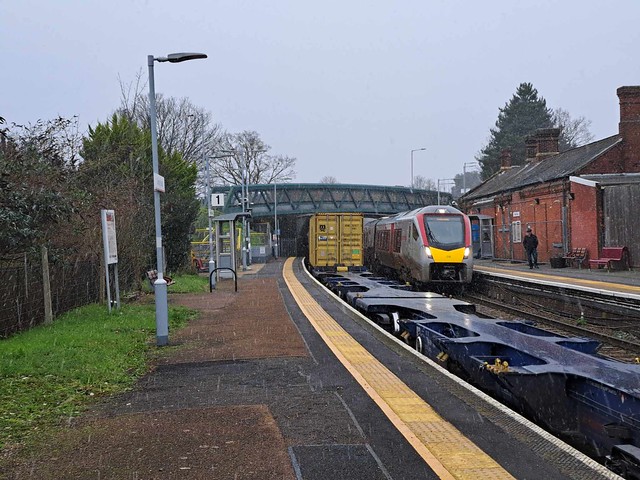 755 326 is passing an intermodal train at Derby Road Station.