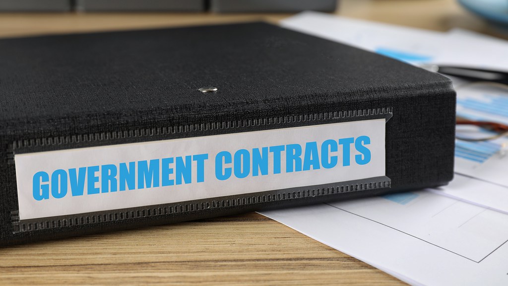 A photo of a folder with the words government contracts on the label