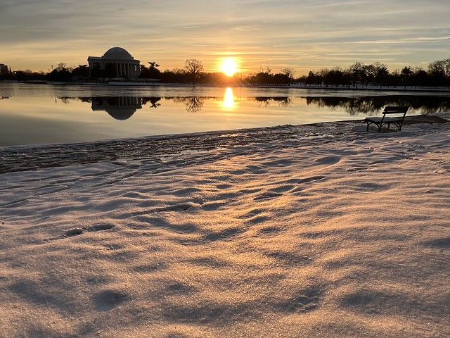 Snow on Thursday showing pink hue in early morning sunlight over the Tidal Basin