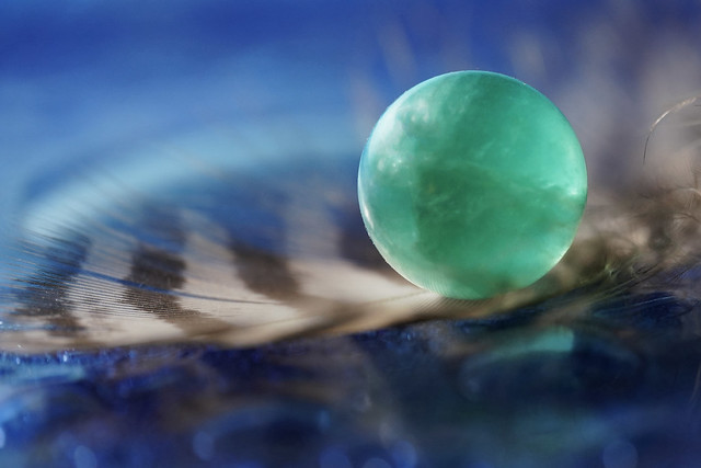 Glass Marble on a Feather