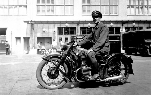 A member of the Deutsche Reichspost on a 'Postschnelldienst' BMW R12 motorcycle with mailbox sidecar circa WW2