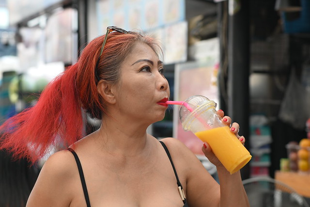 DSC_4041: a woman with red hair drinking from a plastic cup