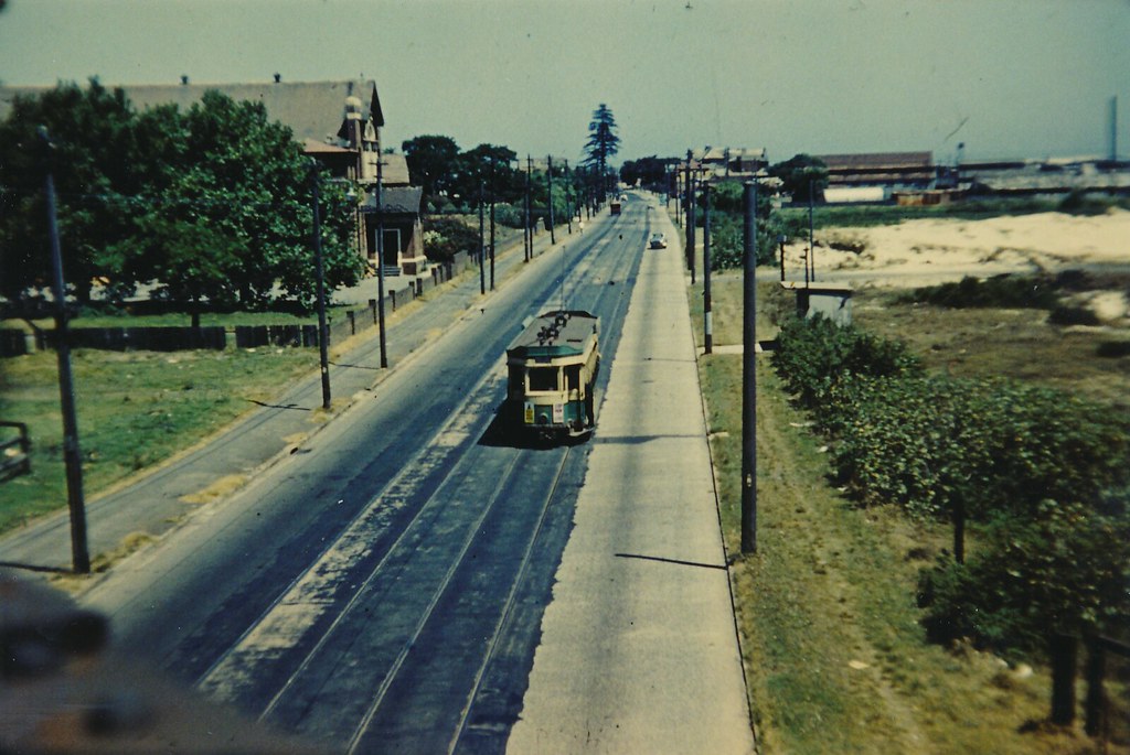 The view off a Railway Bridge to a Tram on Botany Rd