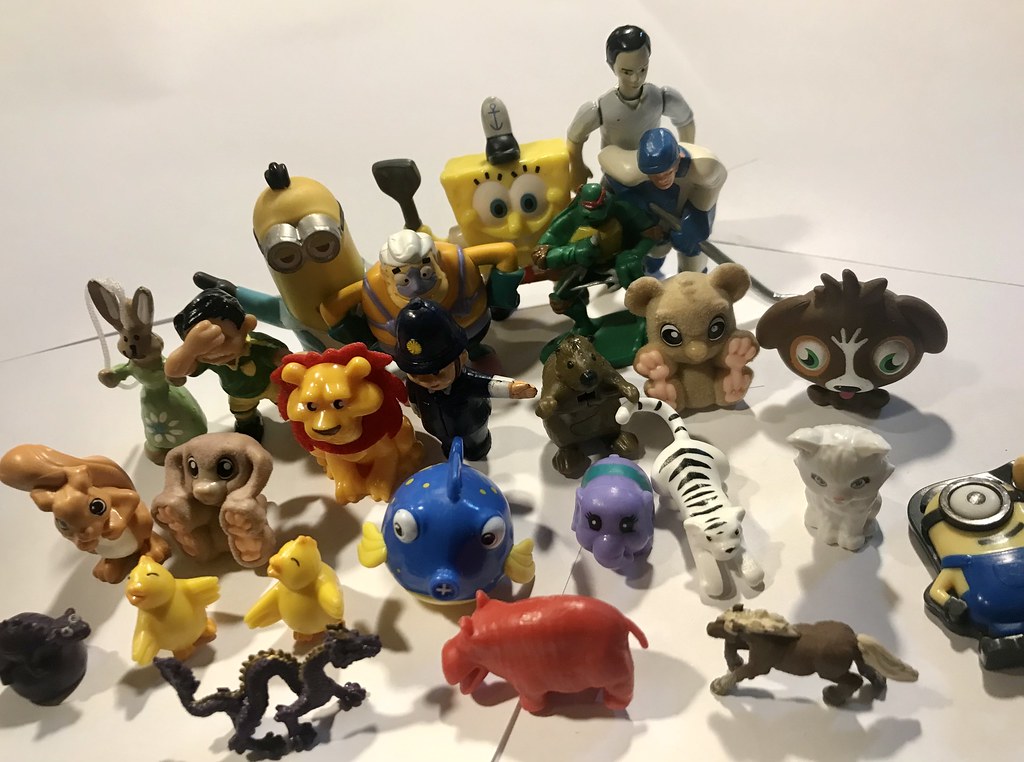 Arrangement of small plastic toys, kinder, minions, football/soccer, dragon, plastic critters, cartoons, disney, spongebob, viacom and pop- toys ( hobby photography )
