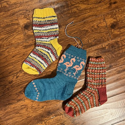 I took this picture of half of 3 pairs that Krystyna knit with only the ends needing to be sewn in. The top one was her very first sock.