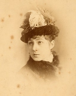 Woman_wearing_egret-feather_hat_ca_1878