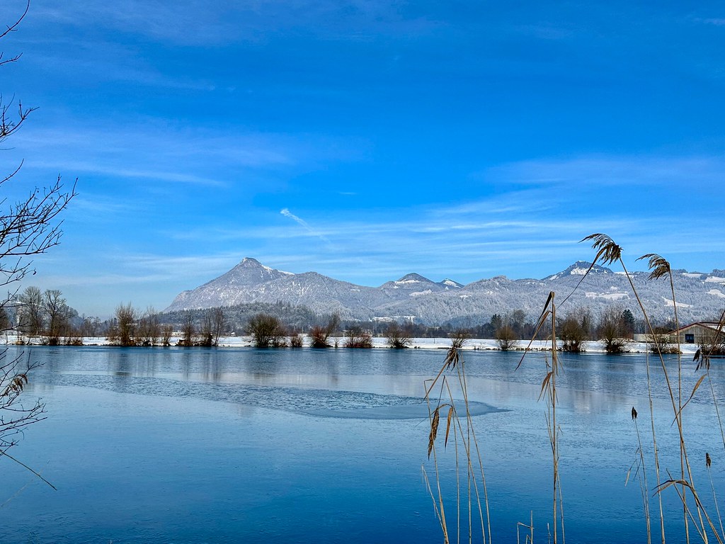 Lake Kreutsee with Kranzhorn mountain in winter near Kiefersfelden in Bavaria, Germany