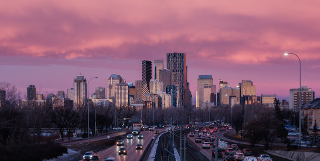Calgary skyline, looking westward, during a pink sunrise.