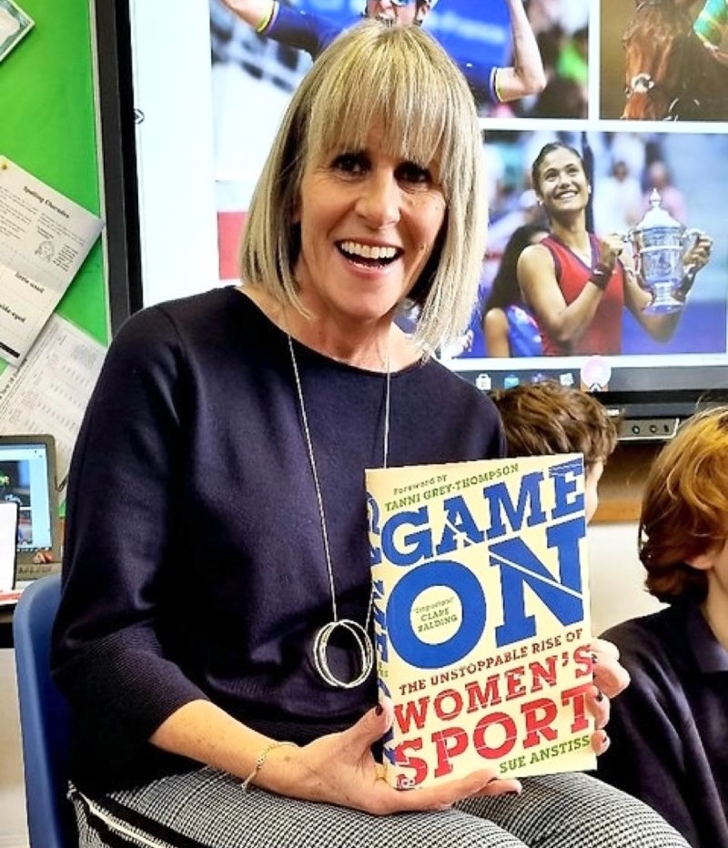 Sue Antsiss presenting a copy of her book 'Game On'.