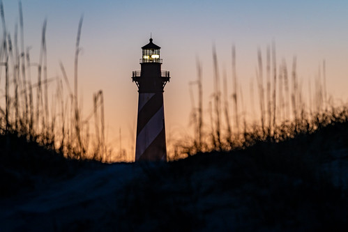 Cape Hatteras Light by Christopher Wallace, Stealing the last sunlight as it slip over the curve of the earth at the Cape Hatteras Light

"