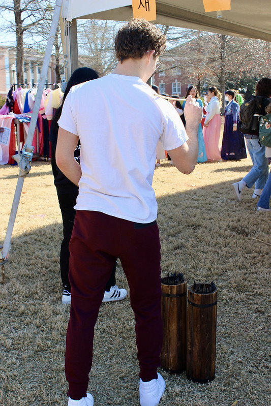 A male student playing Tuho, a traditional Korean game.