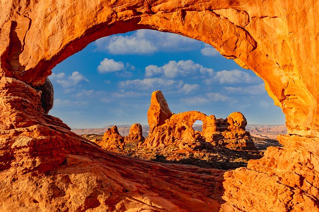 Sunrise on Turret Arch, seen through North Window Arch, in Utah's Arches National Park