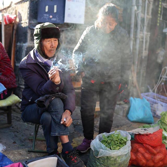 Smoking vendor in the morning market.