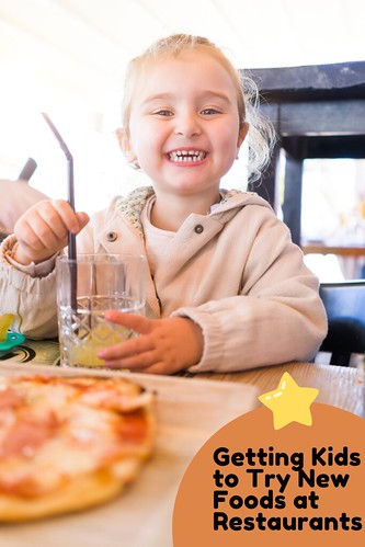 Happy kid at restaurant. From Getting Kids to Try New Foods at Restaurants