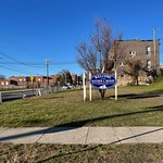 "Matthew A. Henson Neighborhood Association" gateway sign at corner lot, N. Payson Street and Presstman Street (northwest corner), Baltimore, MD 21217 Photograph by Eli Pousson, 2022 December 9.