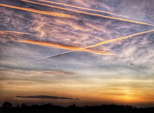 Hallow sunset with kiss plane contrails