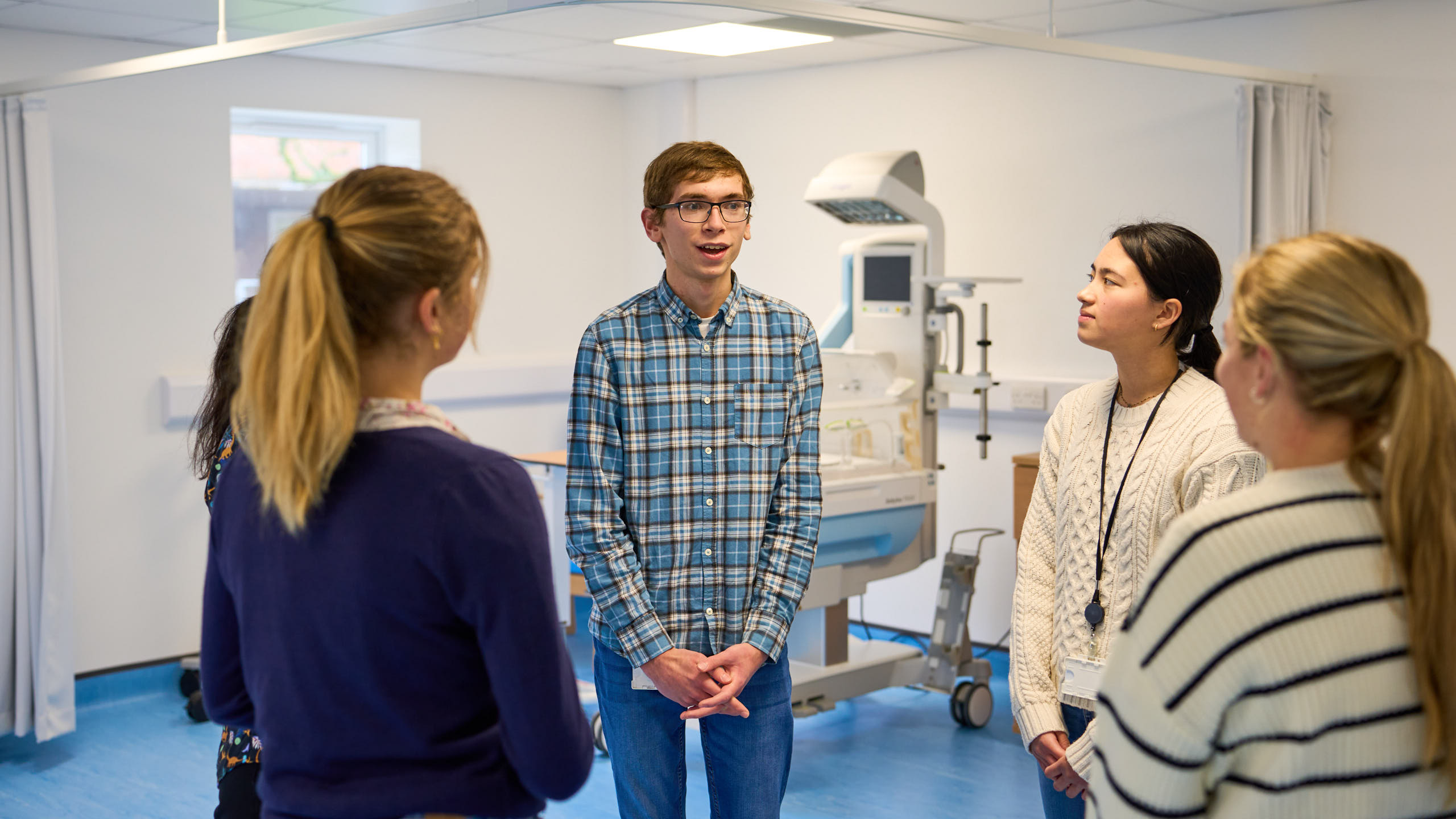 James talks to other students in a lab environment.