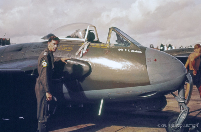 F/O Trevor Bland with his RNZAF 14 Sqn De Havilland Venom at Bangkok Airport during a SEATO Exercise – Air Cobra – in April or May 1962, note the tail of the Vampire T11 in the background