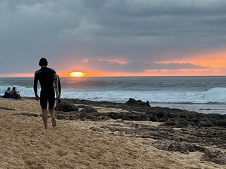 Surfer dude at sunset, Rocky Point, North Shore, Oahu