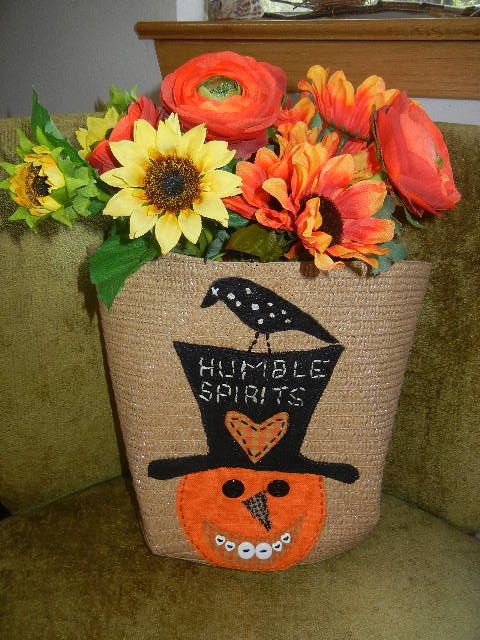 Appliqued straw tote, I sewed, using  Kindred Spirits pattern from the 90's.  Used to hold flowers for Fall/ Halloween season.