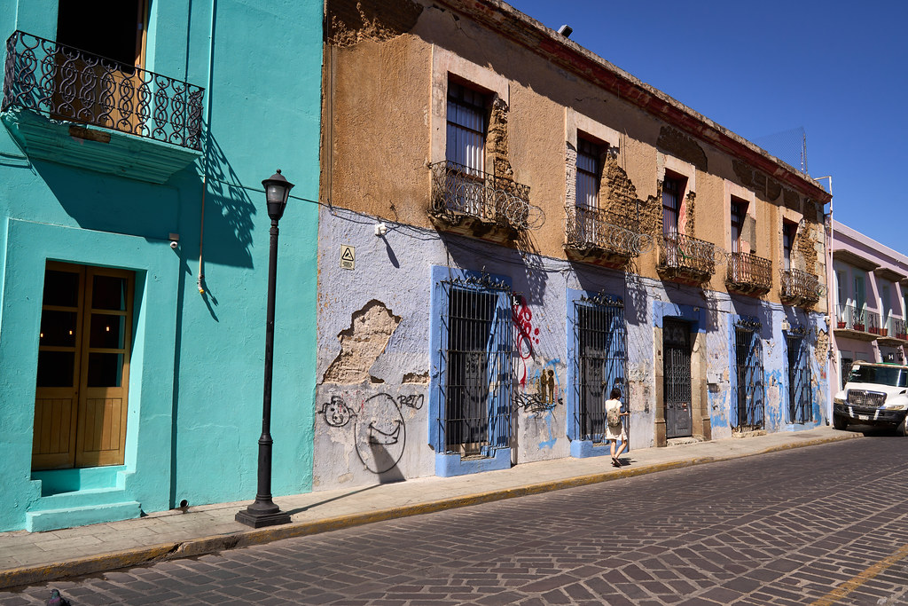 a colorful street scene in Oaxaca (requiring some maintenance)