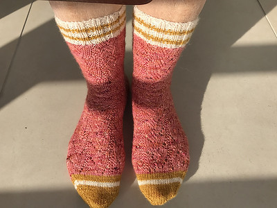 Connie (knitnut246) knit this pair of Cozy Autumn Socks by This Handmade Life for a breast cancer fundraiser.
