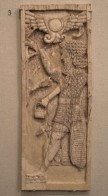 Ivory plaque with bearded figure holding bucket and pinecone or spathe, from Nimrud